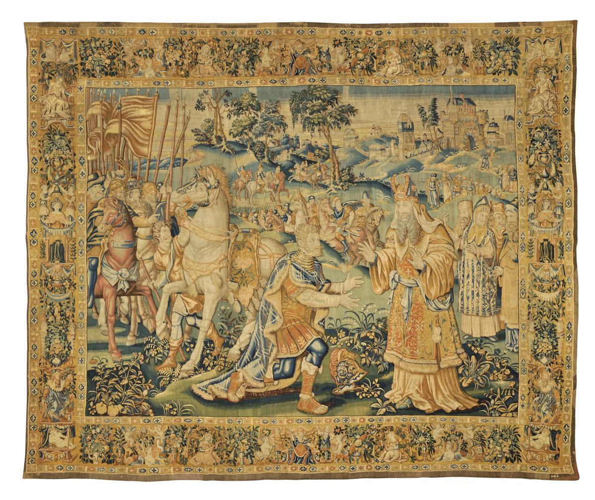 Figural Flemish tapestry, late 16th century, possibly from a History of Alexander or an Old Testament cycle. An armoured ruler bows before a mitred high priest, with cavalry and retinue, in a Flemish Renaissance border of foliage, fruit, putti and corner figures.